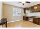 Bedroom featuring light hardwood floors, white shuttered windows, and built-in shelves and cabinets at 19927 N 108Th Ln, Sun City, AZ 85373