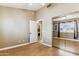 View of the bedroom with light walls, light wood floors, and mirrored closet doors at 19927 N 108Th Ln, Sun City, AZ 85373