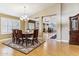 Elegant dining room with hardwood floors, chandelier, and views into the living spaces at 19927 N 108Th Ln, Sun City, AZ 85373