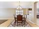 Formal dining room with a chandelier, hardwood floors, and an open view to the fireplace at 19927 N 108Th Ln, Sun City, AZ 85373