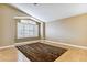 Bright living room with hardwood floors, a large window, vaulted ceiling, and neutral paint at 19927 N 108Th Ln, Sun City, AZ 85373