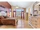 Spacious bedroom featuring light wood floors, a large window and chandelier at 19927 N 108Th Ln, Sun City, AZ 85373