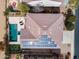 Aerial view of the backyard featuring a pool, solar panels on the roof, and well maintained landscaping at 22050 N Balboa Dr, Maricopa, AZ 85138