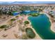 Fantastic aerial view of golf course with mature trees, water features, lush green grass, and gorgeous community at 22050 N Balboa Dr, Maricopa, AZ 85138