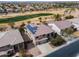 Stunning aerial view of home with solar panels, desert landscaping, and large driveway in a golf course community at 22050 N Balboa Dr, Maricopa, AZ 85138