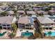 Aerial view of a neighborhood, featuring a home with solar panels and a backyard pool oasis at 22050 N Balboa Dr, Maricopa, AZ 85138