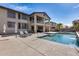 Inviting backyard with a sparkling pool, lounge chairs, and a covered patio, ideal for outdoor living at 22050 N Balboa Dr, Maricopa, AZ 85138