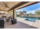 Backyard oasis with pool, spa, seating, and lush landscaping at 22050 N Balboa Dr, Maricopa, AZ 85138