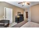 Bedroom with neutral walls and ceiling fan, dark furniture and neutral bedding at 22050 N Balboa Dr, Maricopa, AZ 85138