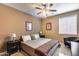 Bedroom with ceiling fan, neutral walls, lamps and an accent chair at 22050 N Balboa Dr, Maricopa, AZ 85138