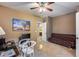 Bedroom with neutral walls, ceiling fan, and connected bath via open door for bright, modern feel at 22050 N Balboa Dr, Maricopa, AZ 85138