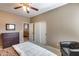 Bedroom showcasing a dresser, closet, neutral walls, ceiling fan, and seating area at 22050 N Balboa Dr, Maricopa, AZ 85138