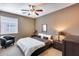 Bedroom featuring a plush bed, ceiling fan, and window providing plenty of natural light at 22050 N Balboa Dr, Maricopa, AZ 85138