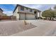 Charming home featuring a three-car garage, desert landscaping, and inviting curb appeal at 22050 N Balboa Dr, Maricopa, AZ 85138