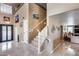 Inviting foyer features a staircase, tile flooring, and decorative lighting fixtures at 22050 N Balboa Dr, Maricopa, AZ 85138