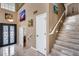 Entryway with decorative glass door, staircase, and access to other rooms at 22050 N Balboa Dr, Maricopa, AZ 85138