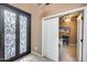 The home's entryway featuring a decorative glass door and access to the dining room at 22050 N Balboa Dr, Maricopa, AZ 85138