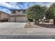 Charming two-story home with large shade trees, a three-car garage, and desert landscaping with beautiful curb appeal at 22050 N Balboa Dr, Maricopa, AZ 85138