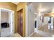 Hallway featuring tile flooring, a built-in cabinet, and doorways leading to various rooms in the home at 22050 N Balboa Dr, Maricopa, AZ 85138