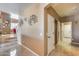 Hallway with stairs, storage closets, art deco wall decor and tile floors at 22050 N Balboa Dr, Maricopa, AZ 85138