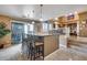 Open concept kitchen with an eat-in island, pendant lighting and steps to formal dining space at 22050 N Balboa Dr, Maricopa, AZ 85138