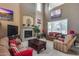 Cozy living room with high ceilings, fireplace, and comfortable seating, perfect for relaxing and entertaining at 22050 N Balboa Dr, Maricopa, AZ 85138