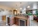 Spacious living area with a granite topped bar that offers views into other living spaces at 22050 N Balboa Dr, Maricopa, AZ 85138