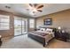 Main bedroom suite with private balcony access and views, complemented by neutral tones and soft lighting at 22050 N Balboa Dr, Maricopa, AZ 85138