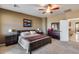 Main bedroom suite with neutral walls, soft carpet, and furnishings, complemented by soft lighting at 22050 N Balboa Dr, Maricopa, AZ 85138