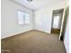 Bright bedroom with a ceiling fan, neutral paint, and large double door closet at 2344 W Barwick Dr, Phoenix, AZ 85085