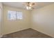 Bedroom featuring neutral walls, carpet, a window, a ceiling fan, and electrical outlets at 2507 E Golden St, Mesa, AZ 85213