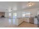 Open kitchen featuring white cabinets, stainless steel appliances, and an island with a breakfast bar at 2507 E Golden St, Mesa, AZ 85213