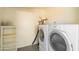 Bright laundry room with stacked washer and dryer at 2507 E Golden St, Mesa, AZ 85213