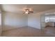 Bright living room featuring tile floors, a ceiling fan, and a view into the updated kitchen at 2507 E Golden St, Mesa, AZ 85213