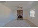 Cozy living room featuring a classic brick fireplace and neutral tones throughout at 2507 E Golden St, Mesa, AZ 85213