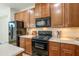 Updated kitchen featuring dark appliances, plenty of cabinets, and neutral countertops with stylish tile flooring at 2722 E Wesson Dr, Chandler, AZ 85286