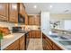 Well-lit kitchen showcasing wooden cabinets, stainless steel appliances, and tile flooring throughout at 2722 E Wesson Dr, Chandler, AZ 85286