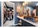 Modern bathroom with stone vessel sink and a view into the stylish walk-in closet at 2726 S Keene --, Mesa, AZ 85209