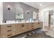 Modern bathroom featuring dual sinks, stylish mirrors, mosaic tile accent wall, and contemporary wood cabinetry at 2920 S Bala Dr, Tempe, AZ 85282