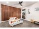 Bedroom with a wood accent wall, carpet, and a comfortable bed at 2920 S Bala Dr, Tempe, AZ 85282