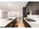 Modern kitchen featuring a large island with sink, stainless steel appliances, and dark cabinets at 2920 S Bala Dr, Tempe, AZ 85282