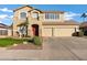 Stunning two-story home showcasing a manicured lawn, a three-car garage, and an inviting front entrance at 3017 S Mesita --, Mesa, AZ 85212