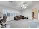 Neutral living room features a ceiling fan, shutters on the windows and comfortable sectional couch at 3017 S Mesita --, Mesa, AZ 85212