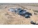 A home under construction, set in a desert landscape, framing is visible and the roof is partially done at 30498 N 232Nd Ave, Wittmann, AZ 85361