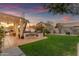 Outdoor kitchen and patio with grill setup and seating, perfect for entertaining in landscaped backyard at 3482 W Shannon St, Chandler, AZ 85226