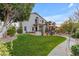 Expansive backyard featuring a lush lawn, mature trees, and a charming patio area perfect for outdoor entertaining at 3482 W Shannon St, Chandler, AZ 85226