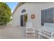 Outdoor balcony featuring seating, sliding glass door, and sun decor on stucco exterior wall at 3482 W Shannon St, Chandler, AZ 85226