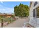 View of a balcony with white metal railing, a white bench, and a lush green tree in the background at 3482 W Shannon St, Chandler, AZ 85226