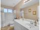 Bathroom with a white vanity, a bathtub with a shower, and a window allowing for natural light at 3482 W Shannon St, Chandler, AZ 85226