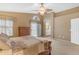 Main bedroom features a dresser, sliding glass door, and an ensuite bathroom, providing a private retreat at 3482 W Shannon St, Chandler, AZ 85226